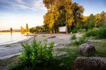 by the water